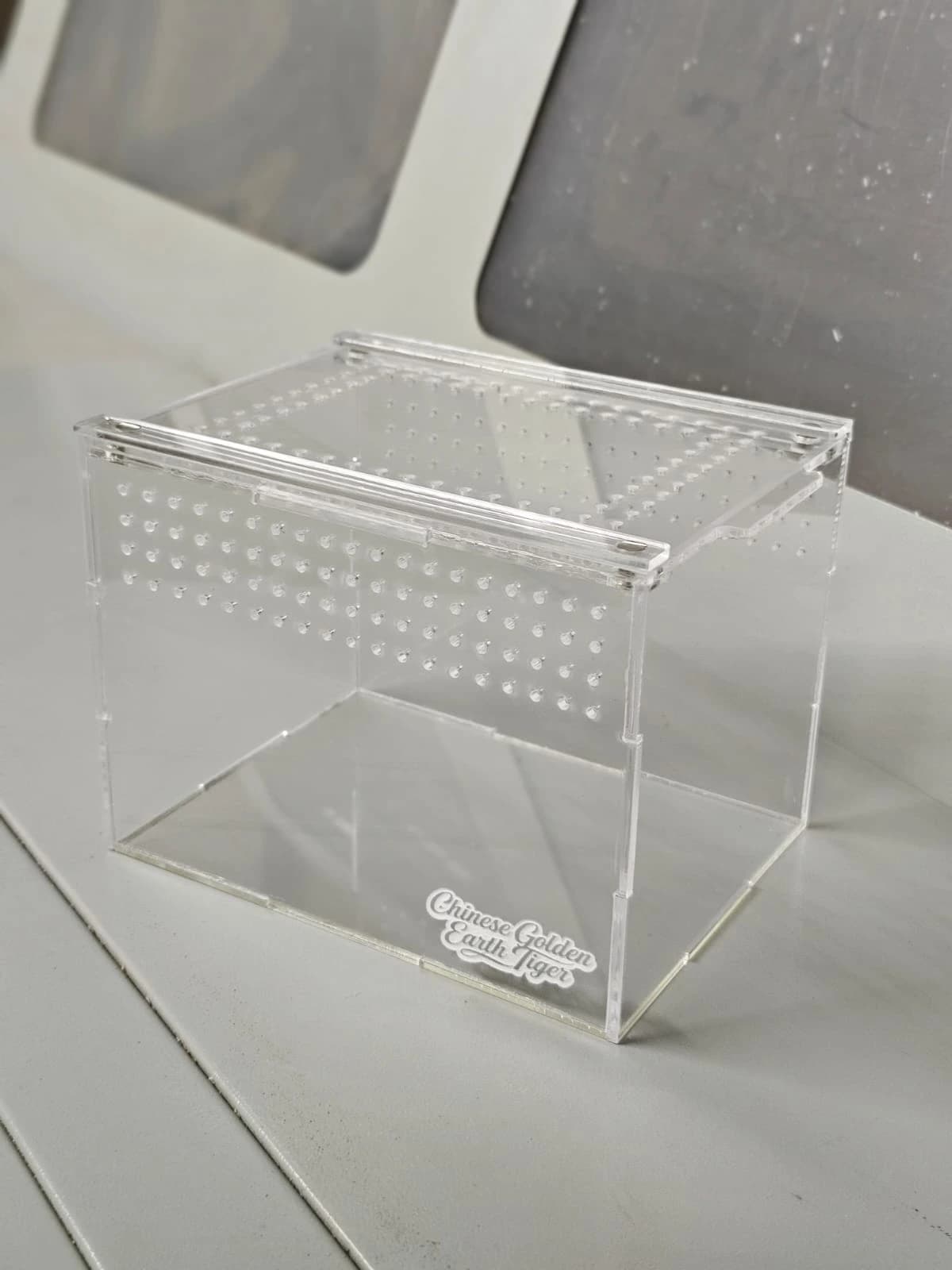 Laser-cut acrylic terrarium enclosure with ventilated lid and branded label