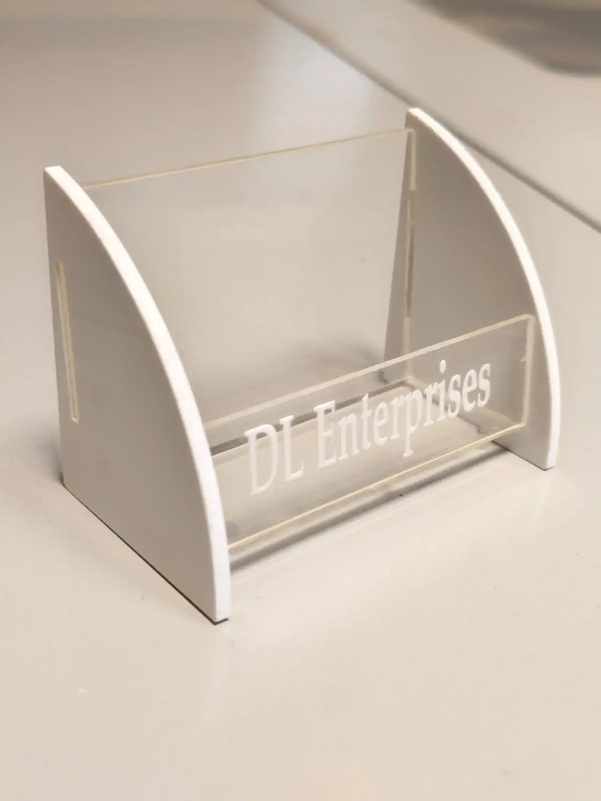 Laser-engraved acrylic and PVC business card holder with DL Enterprises branding
