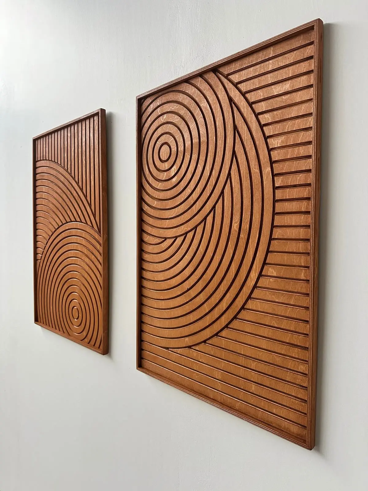 CNC-routed wooden wall art panels with concentric circle and linear groove patterns